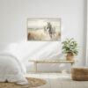 Two Horses Walking on the Beach Wall Art - 3x2 Aspect Ratio - Black Floating Frame Canvas in a Neutral Bedroom with Wooden Bench