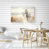 Two Horses Walking on the Beach Wall Art - 3x2 Aspect Ratio - Natural Wood Floating Frame Canvas in a Scandinavian Dining Room with Minimalist Wooden Table and Chairs and Shiplap Walls