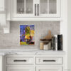 Botanical plant painting in white frame displayed on white painted brick backsplash in elegant kitchen with marble countertops and white cabinets. Impressionist style potted plant artwork with vibrant purple and yellow background, styled with wooden cutting board, spice jars and cookbooks. Perfect for farmhouse kitchen wall decor, modern traditional style, or chef's kitchen art above countertop. Colorful accent piece for neutral white kitchen design.