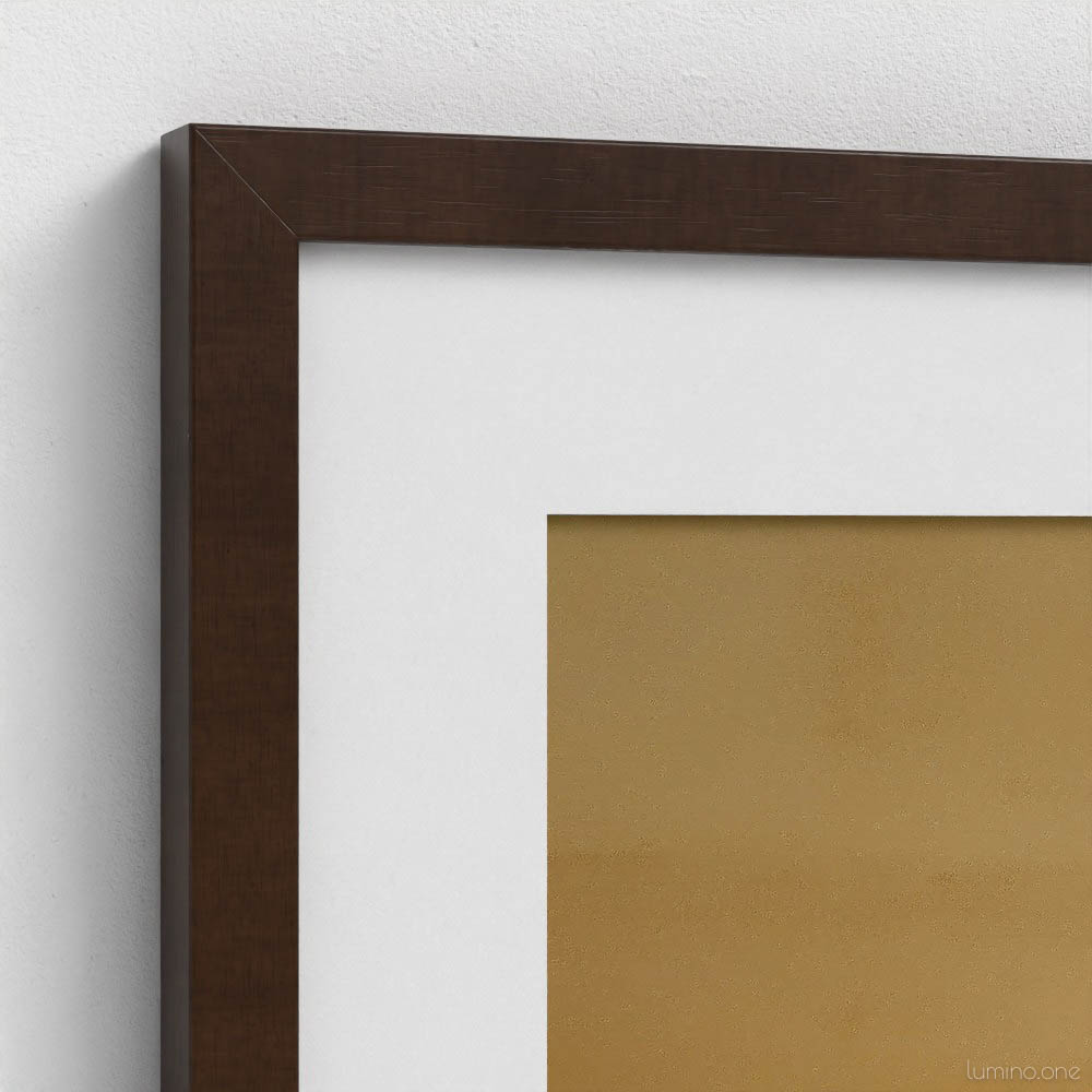 Close-up corner detail of dark brown wooden picture frame with crisp white mat surrounding botanical artwork. The clean corner junction shows the precision craftsmanship where frame meets mat, highlighting the elegant contrast between the rich brown wood frame, bright white matting, and warm tan background of the floral print. Professional framing detail perfect for enhancing botanical wall art in home décor.