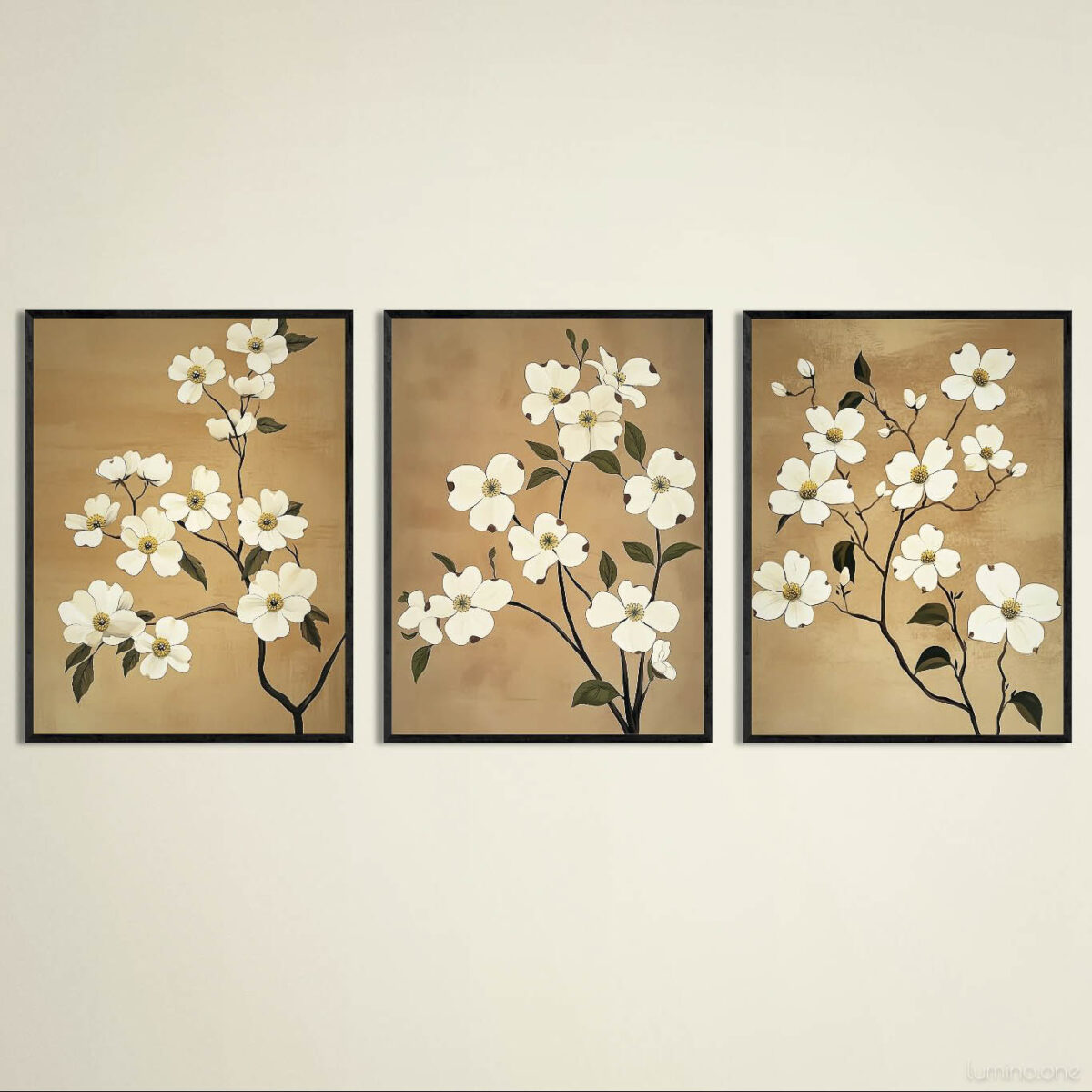 Set of three botanical wall art prints featuring white dogwood flowers on warm tan backgrounds in sleek black frames. Elegant floral triptych displayed against neutral cream wall showing detailed branch arrangements with delicate white blossoms and dark green leaves. Coordinated artwork set creates harmonious focal point with varying compositions of the same botanical theme.