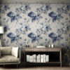 Classic blue peony toile wallpaper displayed in reading nook corner with wood furniture, cozy chair and bright natural light