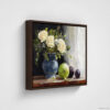 Still life oil painting framed canvas print featuring white roses in a blue ceramic vase with fresh green apple and dark plums on wooden table, displayed in brown floating frame against white background