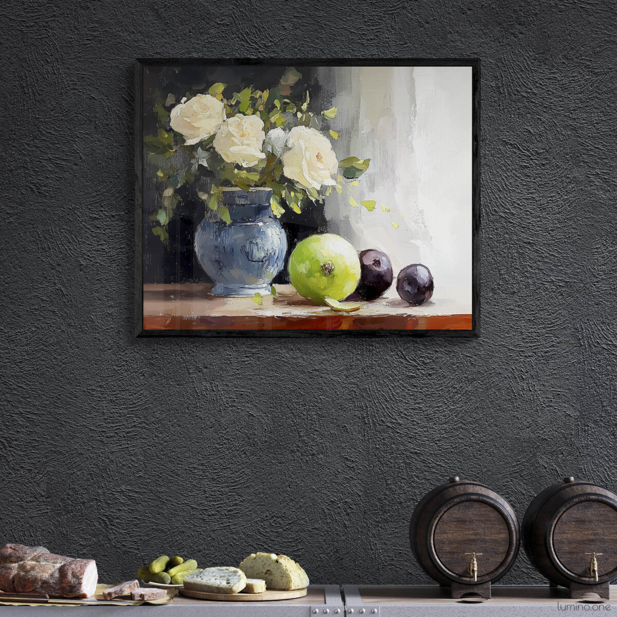 Framed still life oil painting print featuring white roses in a blue ceramic vase with fresh green apple and dark plums on wooden table, displayed in wine cellar or bar area with dark textured walls above industrial metal shelving with cheese board and wine barrels