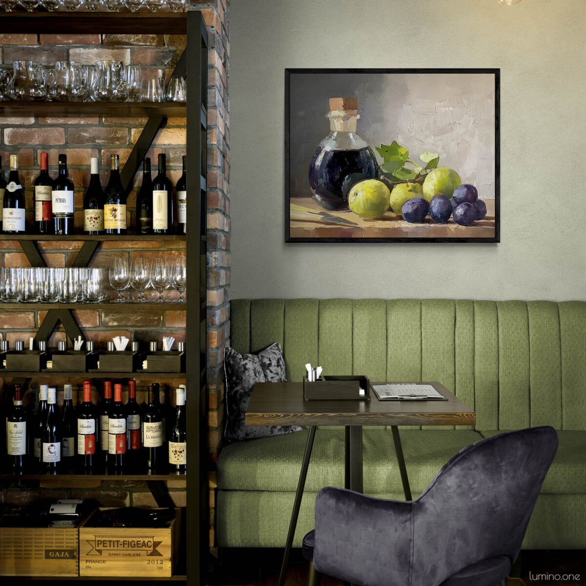Framed still life oil painting print featuring green grapes, dark wine bottle with cork, and blue grapes arranged on wooden surface, displayed in wine bar or restaurant with exposed brick wine storage shelves, green banquette seating, and purple velvet chairs