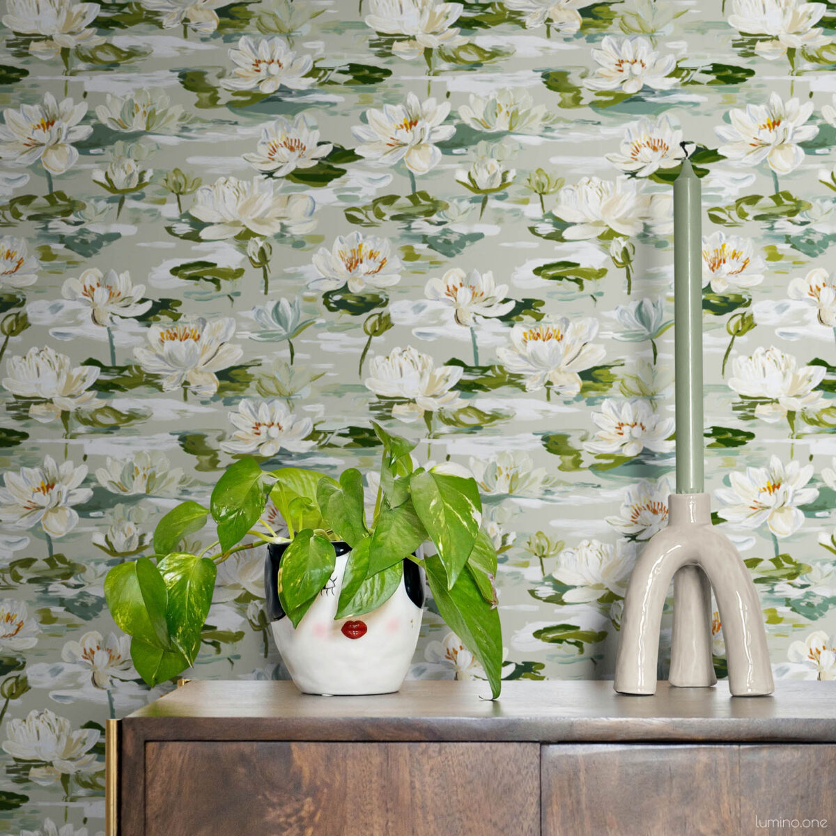 Contemporary dining space with white water lily botanical wallpaper behind mid-century walnut credenza with marble top, sage green modern faucet, white ceramic cow planter with pothos plant creating a fresh natural aesthetic