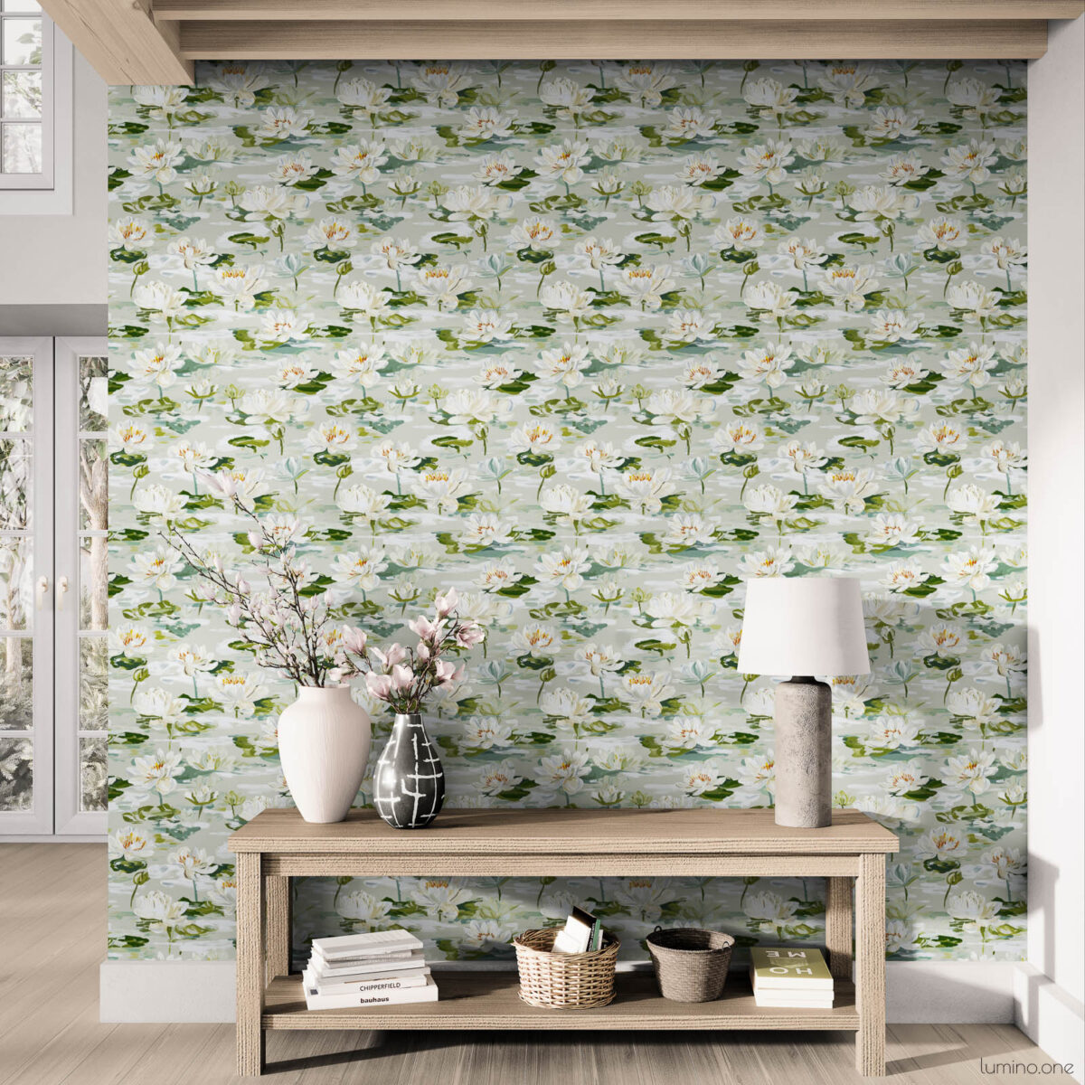 Coastal farmhouse entryway featuring white water lily peel and stick wallpaper with exposed wood beam ceiling, light oak console table styled with ceramic vases, white table lamp, and natural woven baskets on light wood flooring