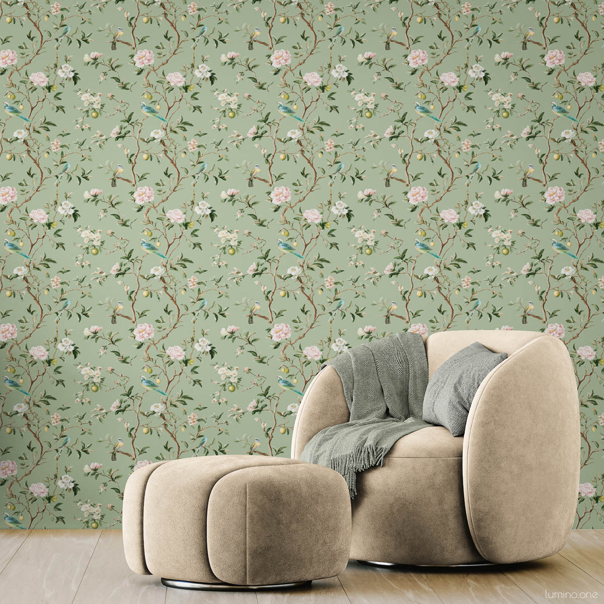 Sage green chinoiserie peel and stick wallpaper with hand-painted birds, pink peonies, and lemon branches in modern living room with beige curved chair, wooden credenza, and white ceramic vases