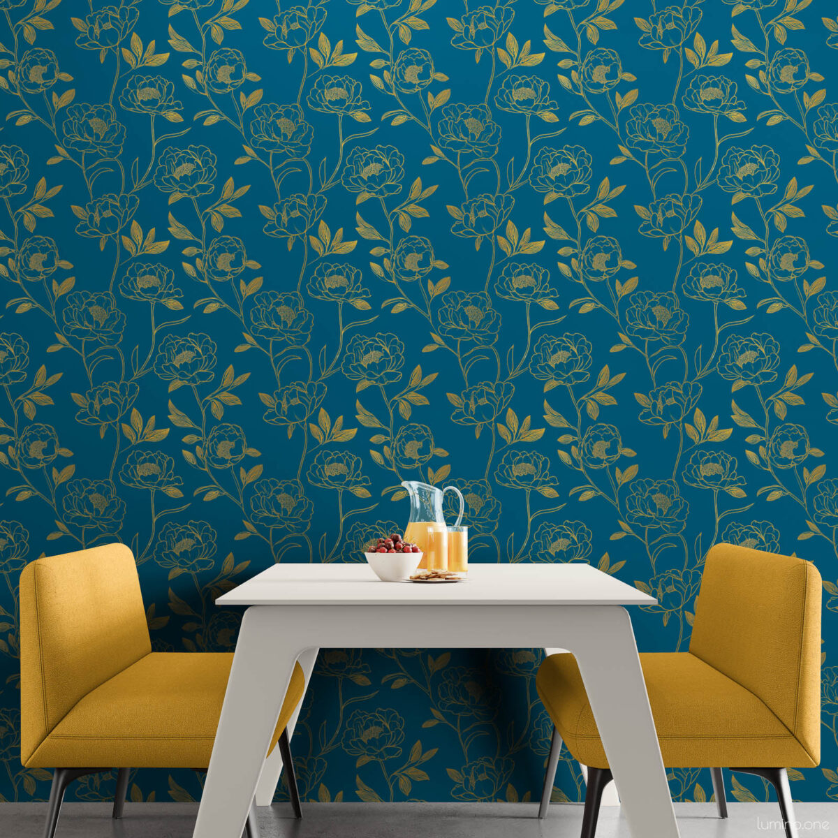 Bright dining nook with full wall dark teal and gold peony peel and stick wallpaper, paired with a white modern table and two mustard yellow accent chairs on concrete floors