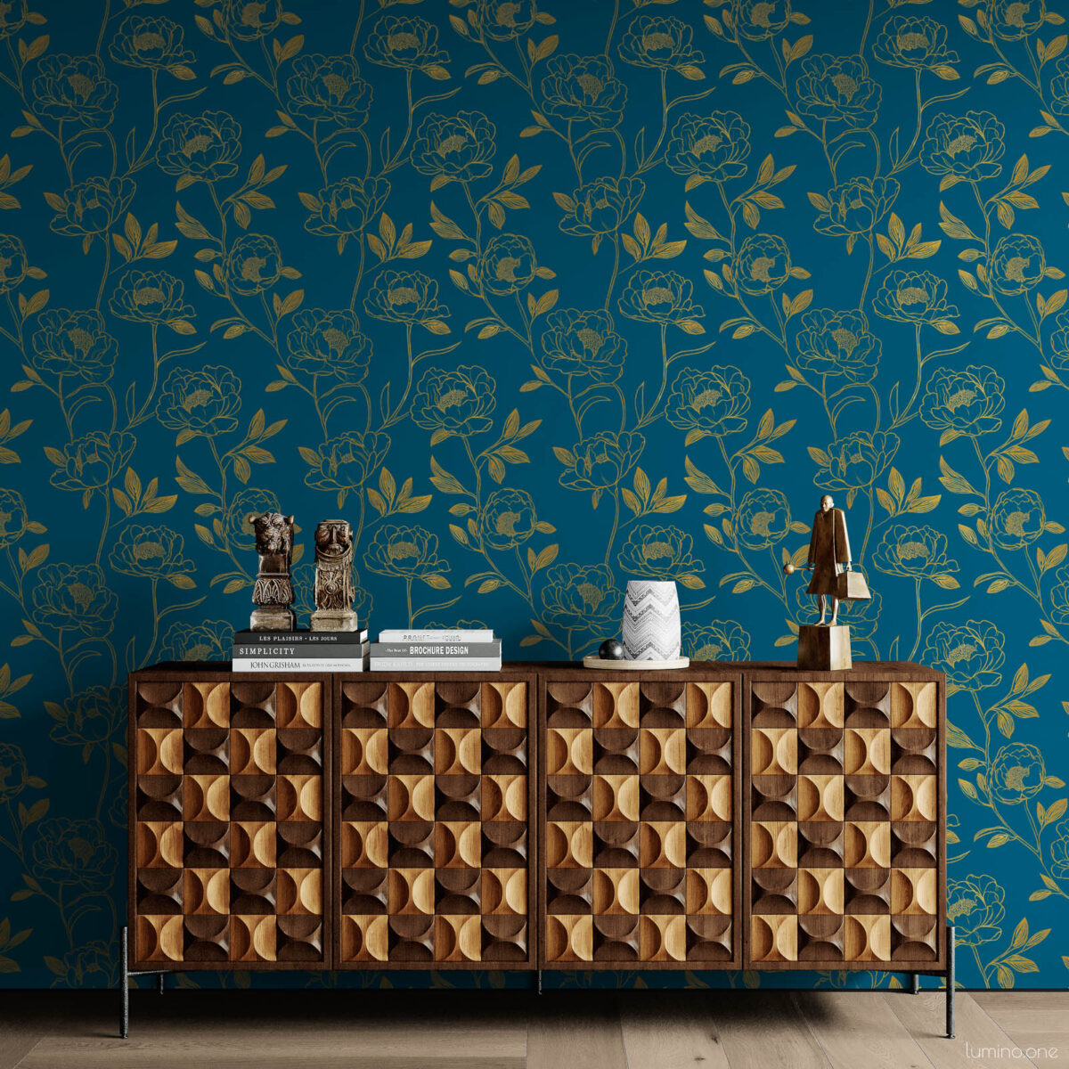 Maximalist living room wall covered in dark teal and gold botanical peony removable wallpaper, styled with a geometric carved walnut credenza topped with sculptural art objects and stacked books on light wood floors